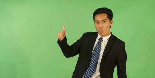 Adult Man in Suit Gives Thumbs Up on Greenscreen