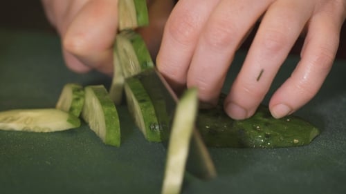 Woman Cutting Vegetables In The Kitchen.