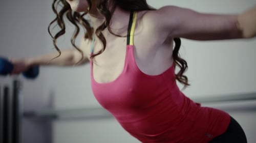 She Works With a Dumbbell In The Gym