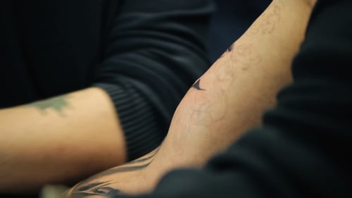 Artist Tattooing Arm Close Up