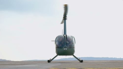 Stationary Helicopter on Airfield with Spinning Blades