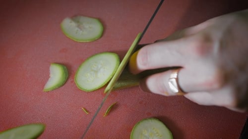 Slicing Fresh Zucchini on Cutting Board