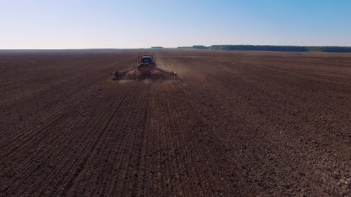 Modern Tractor Plowing Dry Field, Preparing Land For Sowing