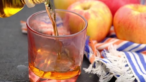 Apple Juice Being Poured Into Glass Still Life