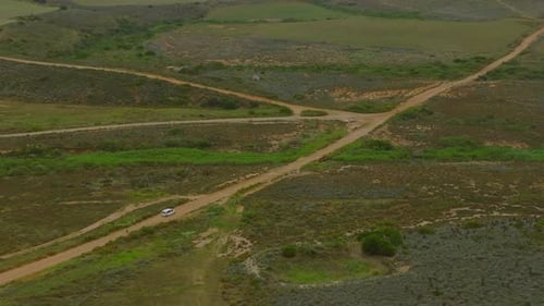 Slowly Driving Car on Dirt Road in Countryside