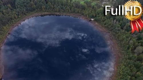 Aerial Video on Round Lake in a Forest With a