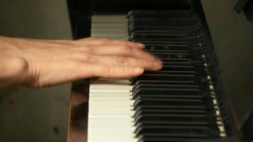 Close-Up of Hands Playing Piano Keyboard