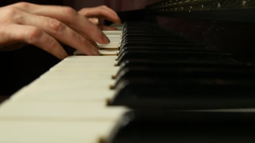 Hands Playing Piano Keys Close Up