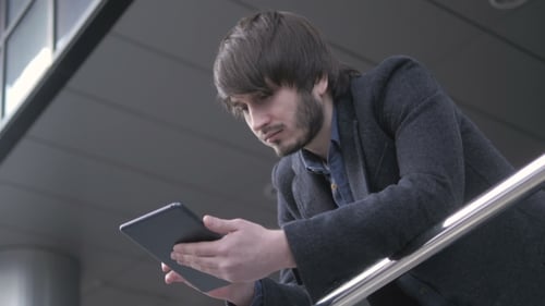 Handsome Hipster Modern Man Using Tablet In The City