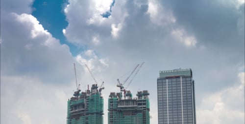 City Buildings and Construction Against Cloudy Sky