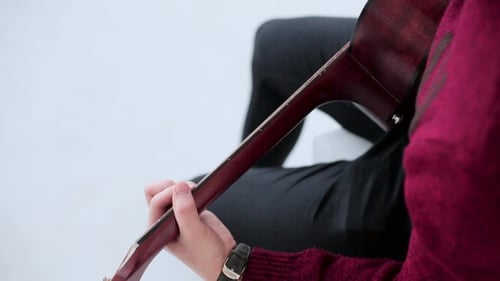 Man Playing An Acoustic Guitar On The White Studio Background