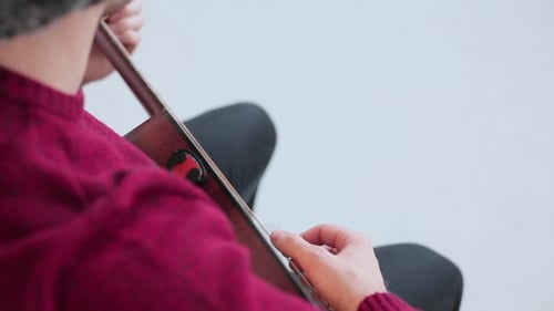 Person Playing Acoustic Guitar Close Up