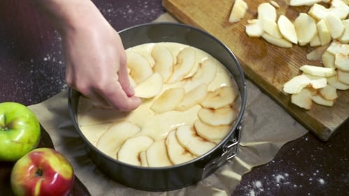 Person Preparing a Delicious Apple Pie Dessert