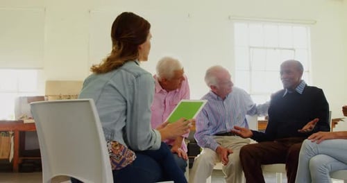 Adults Sitting Together in Circle Meeting Indoors