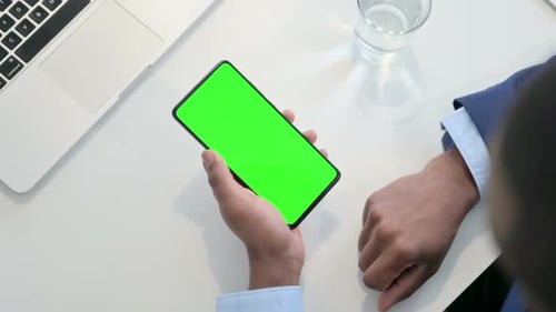 Businessman Using Smartphone with Green Chroma Key Screen