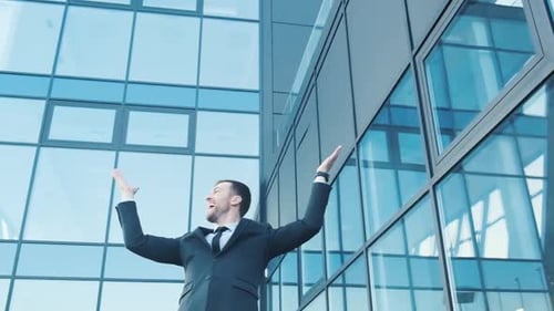 A Young Smiling Office Worker He Spread His Arms Wide Looks Around and Rejoices