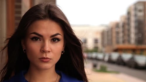 Woman Smiling Gently in Urban Close Up