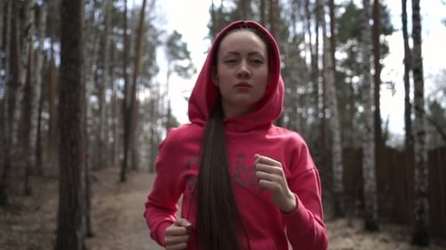 Young Woman Jogging In The Park