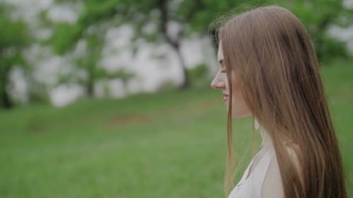 Beautiful Woman in Park with Purple Cloth