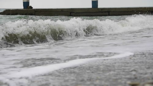 Foamy Sea Waves Spreading Over The Beach In Cloudy Wather
