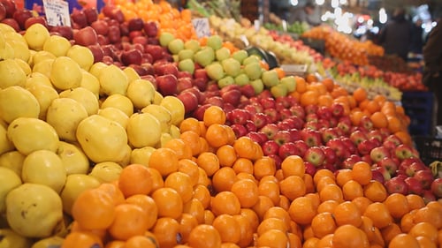 Vibrant Fruit Stand With Oranges and Apples
