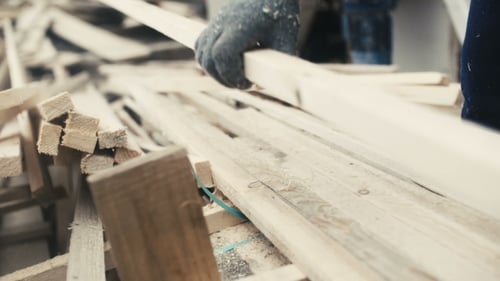 Man Working With Wood At Sawmill