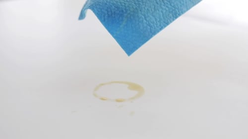 Cleaning Table Top with Rag and Yellow Gloves