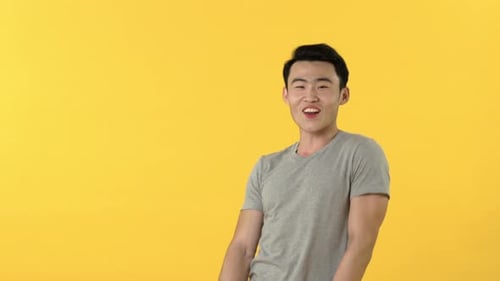 Smiling Man Talking on Yellow Background