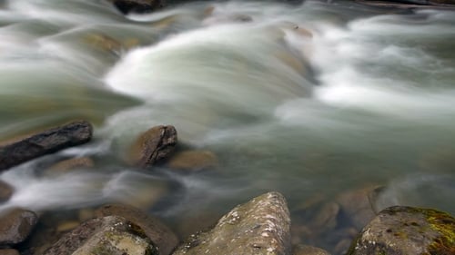Abstract View Of Rushing Water Flowing Down The River
