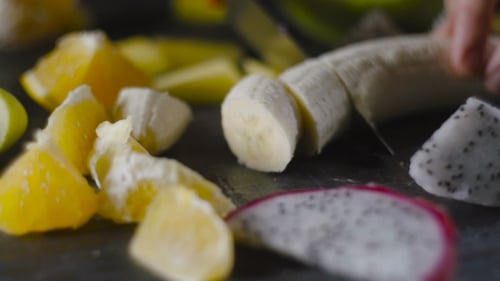 Chef Slicing a Banana Into Thin Slices