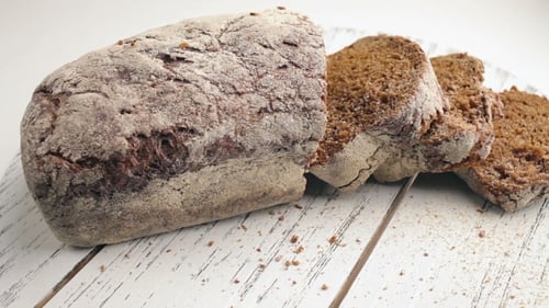 Sliced Brown Bread on White Wooden Board