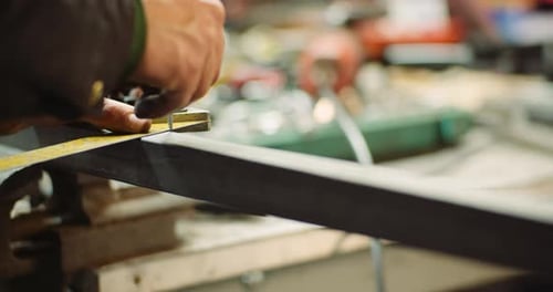 Man Working at Metal Industry - Cutting and Measuring Metal Parts at Workshop