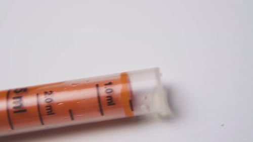 Orange Liquid Medicine in Syringe Close-Up