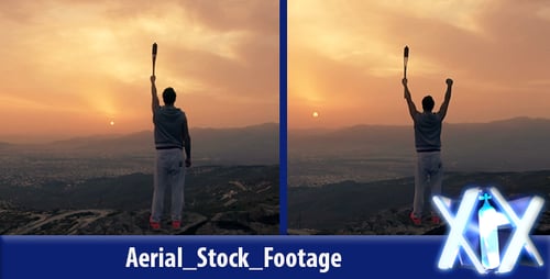 Triumphant Young Adult with Torch on Mountain Peak