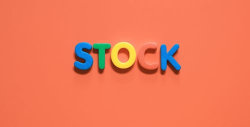 Colorful Letters Spell Word Stock on Orange Background