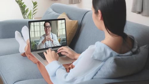 Woman Uses Laptop for Telehealth Doctor Appointment