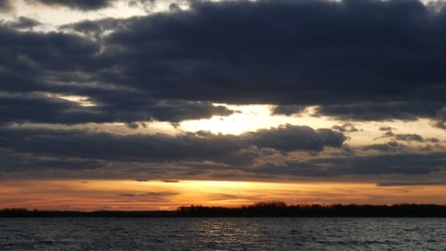 Lake Shimmers Under Colorful Sunrise Sky