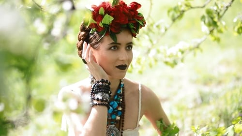 Woman with Flower Crown Posing in Nature