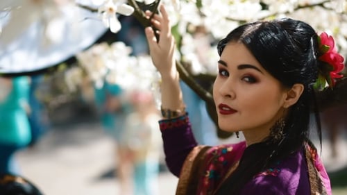 Woman Posing by Blooming Tree in Springtime