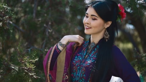 Glamorous Woman Posing Elegantly in a Green Environment