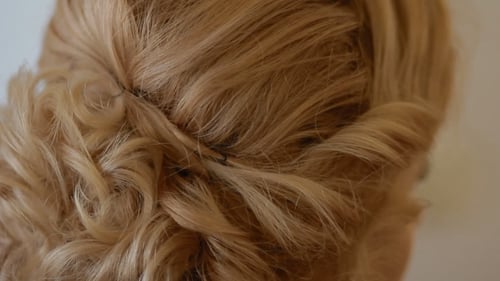 Close Up Of Hair Being Styled Into Bun