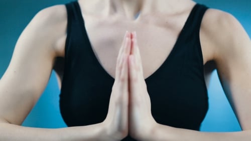 Woman Meditating with Hands Together in Prayer