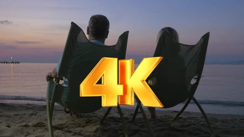 Mature Couple Relaxing On The Beach And Drinking Cocktails