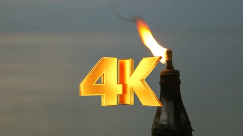 Dramatic Flame atop Architectural Spire at Twilight