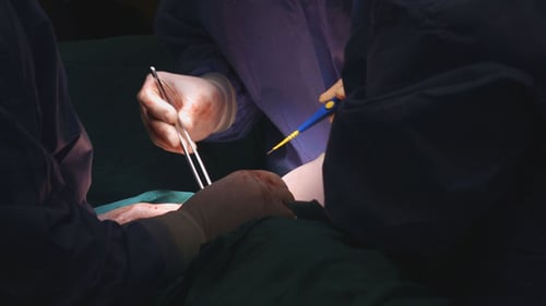 Surgeons Perform Surgery in Hospital Operating Room