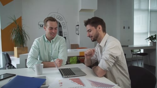 Two Handsome Men Have Friendly Conversation At Creative Hipster Office