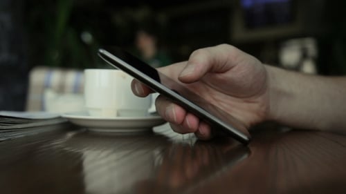 Man Using Smartphone In Cafe