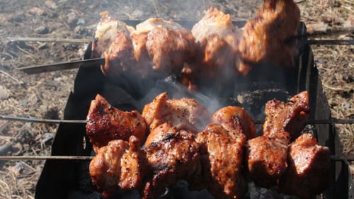 Barbecue Meat Cooking on Grill with Smoke