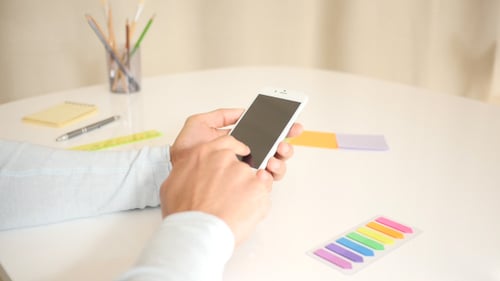 Hands Using Smartphone at Desk, Technology Close Up