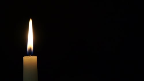 Burning Candle Isolated on Black